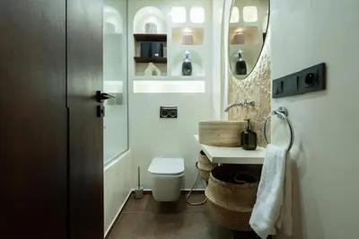 a bathroom with a toilet and a sink and a mirror at Central Cosy 2BR 2 Baths, Balcony & Clear View in Casablanca