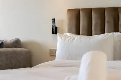 a bedroom with a bed with a pillow and a chair at Terrasse Horizon Marina in Casablanca