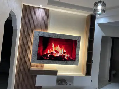 a fireplace in a living room with a fire at Elégant appartement 2 Bedroom près de la plage Rabat in Rabat