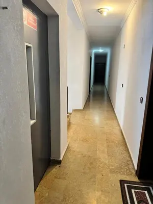 an empty hallway with a hallway leading to a door at Elégant appartement 2 Bedroom près de la plage Rabat in Rabat