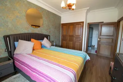 a bedroom with a large bed with a mirror on the wall at good Nice appartement in Casablanca