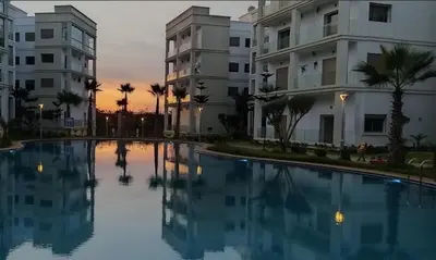 a large swimming pool in front of some buildings at Costa Beach 2 in Bouznika