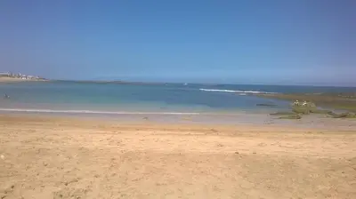 a beach with the ocean in the background at Apartment with sea view in El Harhoura