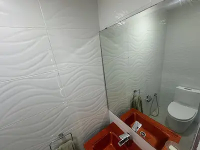 a small bathroom with a toilet and a shower at Seaside apartment in El Mansouria in Mansouria