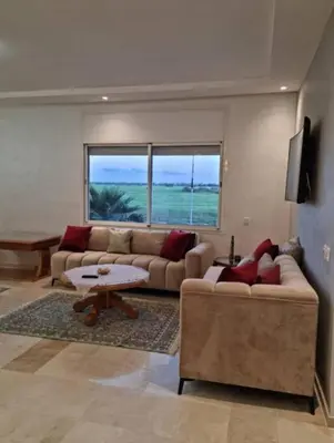 a living room with two couches and a table at Appartement de luxe avec piscine à Mansouria in Mansouria