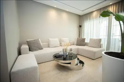 a living room with a white couch and a table at Where to stay in Casablanca 2 bedrooms in Casablanca