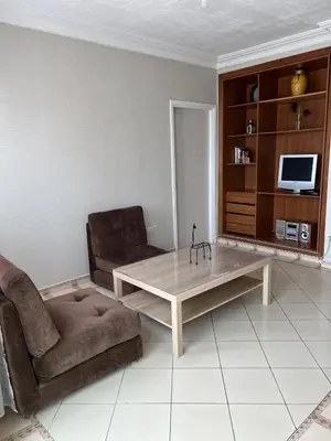 a living room with a couch and a coffee table at Un agréable studio au quartier Maarif à Casablanca in Casablanca