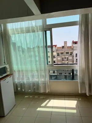 a kitchen with a large window with a view of a building at Un agréable studio au quartier Maarif à Casablanca in Casablanca