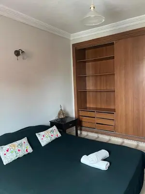 a bedroom with a bed with two pillows on it at Un agréable studio au quartier Maarif à Casablanca in Casablanca