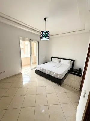 a bedroom with a bed and a large window at Coastal serenity oasis in El Jadida