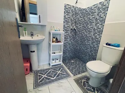 a bathroom with a white toilet and a sink at Appartement cosy avec vue jardin à Casablanca ! in Casablanca
