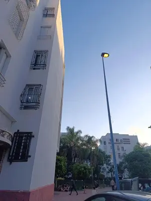 a street light next to a white building at Logement tout confort, équipé ! in Casablanca