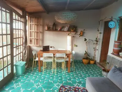 a dining room with a table and chairs on a blue floor at Birds House in Casablanca
