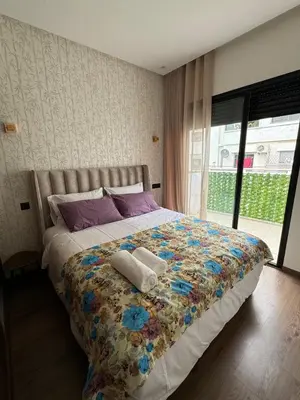 a bedroom with a bed with two towels on it at Beautiful apartment with a terrace in Casablanca