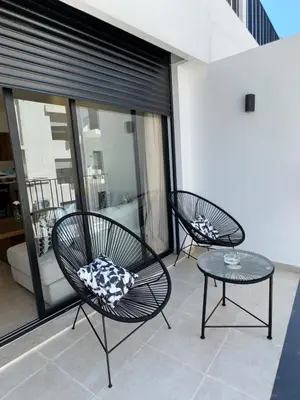 two chairs and a table on a balcony at Beautiful apartment with a terrace in Casablanca