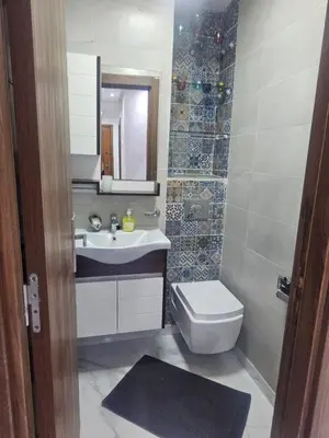 a bathroom with a sink and a toilet and a mirror at Malaga el Mansouria valence in Casablanca