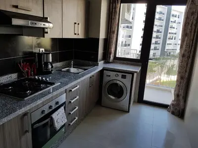 a kitchen with a sink and a washing machine at Luxury apartment in Hay Riad, Prestigia, Rabat in Rabat