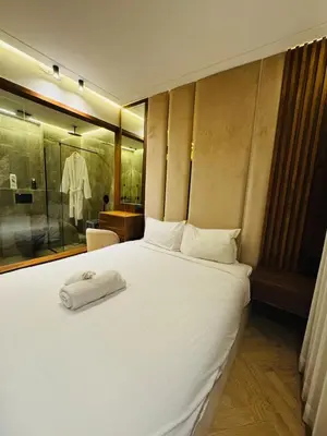 a bedroom with a white bed with a towel on it at CYPRessa Loft - Nature and Serenity - Corniche Access in Casablanca