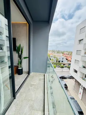 a balcony with a view of a building at CYPRessa Loft - Nature and Serenity - Corniche Access in Casablanca