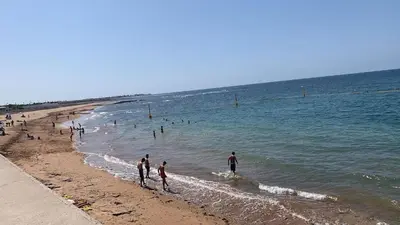 a group of people playing in the water at the beach at Bahia Golf Beach Odyssée Appt Familial Bord De Mer in Bouznika