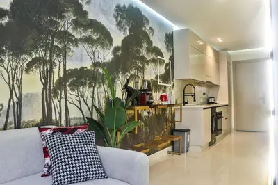 a living room with a couch and a kitchen at Studio de luxe Vue Mer corniche casablanca in Casablanca