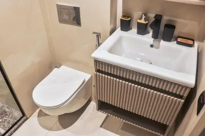 a bathroom with a white toilet and a sink at Studio de luxe Vue Mer corniche casablanca in Casablanca