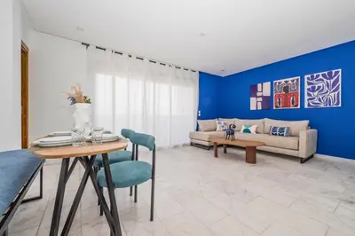 a living room with a table and a couch at CASA B l'hôtel in Casablanca