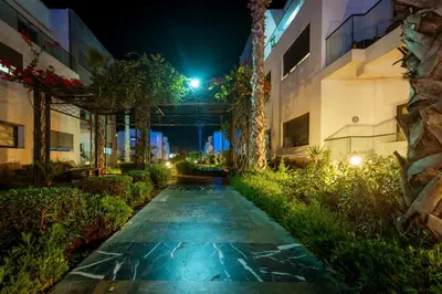 a walkway between two buildings at night at Garden Bay Signature AppartHotel in Casablanca