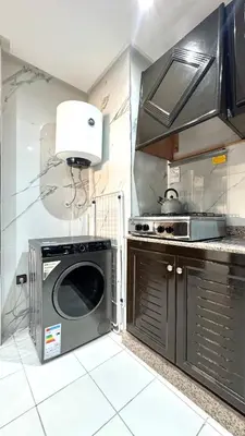 a kitchen with a microwave oven and a stove at Charming home in Temara in Temara