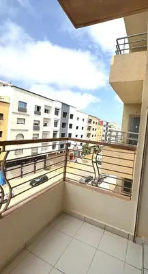 a balcony with a view of a building at Charming home in Temara in Temara