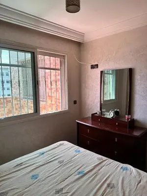 a bedroom with a bed and a dresser and a mirror at Casa fbelvedère in Casablanca