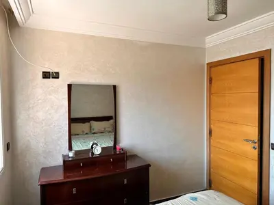 a bedroom with a wooden dresser and a mirror at Casa fbelvedère in Casablanca