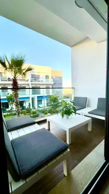 a living room with couches and tables on a balcony at Garden Bay Luxe, Tamaris Bord de Mer in Casablanca