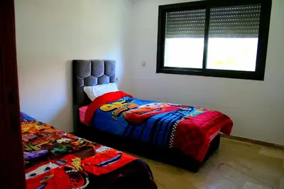 a bedroom with two beds and a window at Garden Bay Luxe, Tamaris Bord de Mer in Casablanca