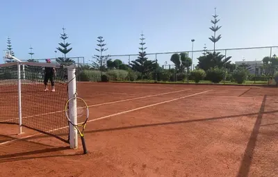 a tennis net on a tennis court at Appartement avec Terrasse, Piscine & Plage à Ola Blanca 2 in Sidi Rahal