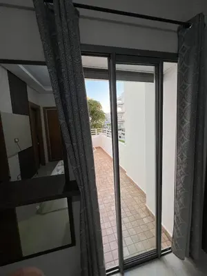 a sliding glass door with a view of a balcony at Apartment in a residence in Pont Blondin