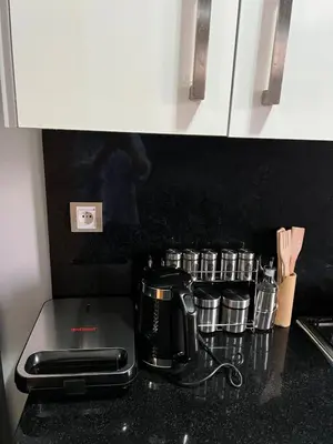 a kitchen counter with a toaster and a coffee maker at Apartment in a residence in Pont Blondin