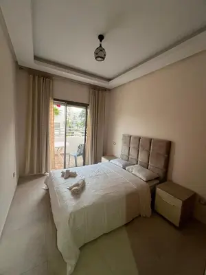 a bedroom with a large bed and a window at Apartment in a residence in Pont Blondin