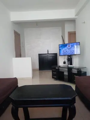 a living room with a couch and a tv at Appartement à Skhirat in Skhirat