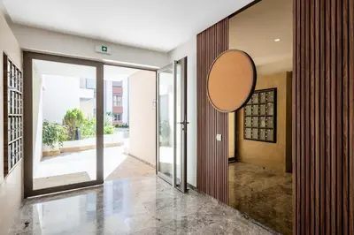a hallway with sliding glass doors and a mirror at Chic, bright, 2 BR apartment, panoramic view in Temara