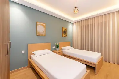 a bedroom with two beds and a window at Chic, bright, 2 BR apartment, panoramic view in Temara