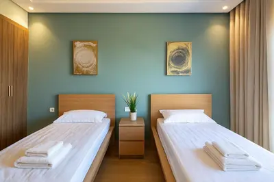 two beds sitting next to each other in a bedroom at Chic, bright, 2 BR apartment, panoramic view in Temara