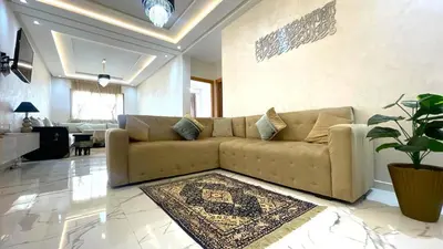 a living room with a couch and a rug at Maison Safran à Bouznika calme confort et authenticité à deux pas de la plage in Bouznika