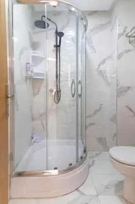 a shower with a glass door in a bathroom at Maison Safran à Bouznika calme confort et authenticité à deux pas de la plage in Bouznika