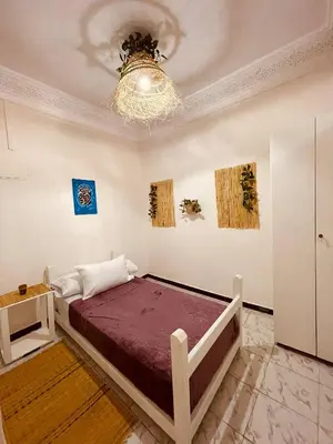 a bedroom with a bed and a chandelier at Attractive Studio in Casablanca in Casablanca