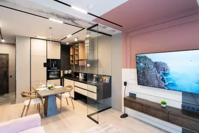 a living room with a large flat screen tv on a wall at charcho place in Les Camps