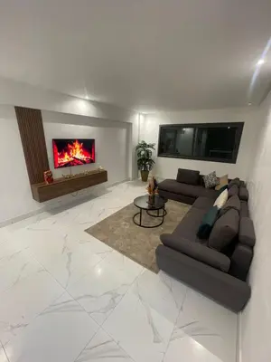 a living room with a couch and a fireplace at Casawi in Casablanca