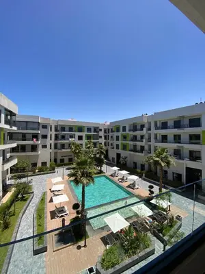an apartment with a swimming pool and a resort at Natura Appartement Pool View by 7AV Hotels in Mohammedia