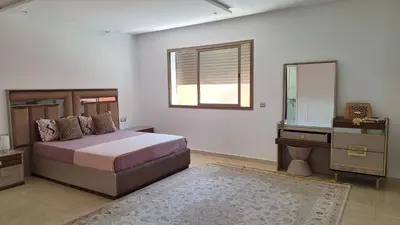 a bedroom with a bed and a dresser and a mirror at Suites au sein d'une Villa au centre ville de Rabat in Rabat