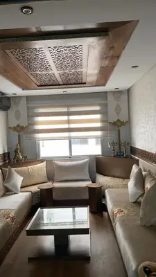 a living room with a couch and a coffee table at Appartement Prestige à Rabat Océan - 2min de la Plage in Rabat